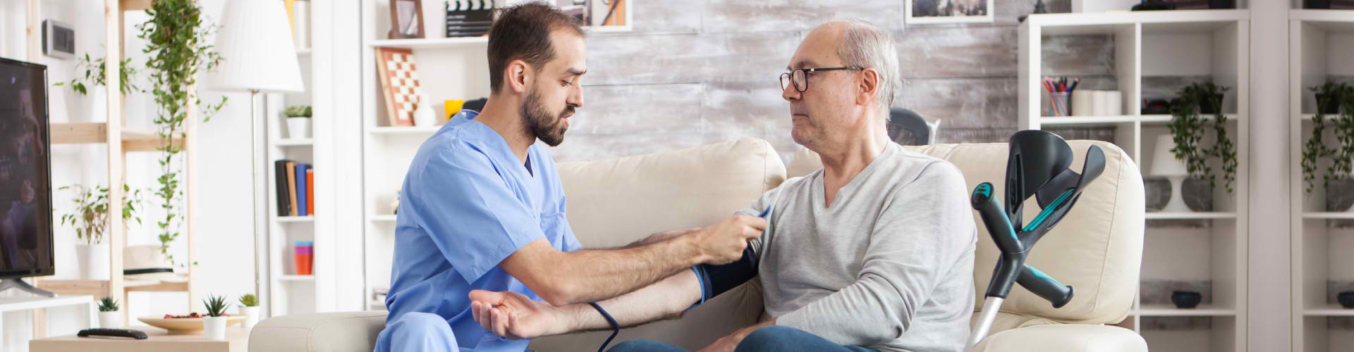 A caregiver assisting a senior at home